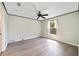 The bedroom features wood-look flooring, a ceiling fan, neutral walls, and a window with natural light at 10562 Bridlewood Ave, Orlando, FL 32825