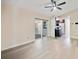 Open floor plan integrates the living room and kitchen, enhanced by wood-look flooring and a ceiling fan at 10562 Bridlewood Ave, Orlando, FL 32825