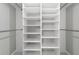 Large walk-in closet with built-in shelving for ample storage space at 10562 Bridlewood Ave, Orlando, FL 32825