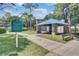 A covered shelter with a picnic table and bench seating beside a paved walkway at 112 Tate Ct, Orlando, FL 32828