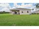 Lush backyard with covered patio, showing home's outdoor living space and lawn at 1134 Clay Blvd, Tavares, FL 32778