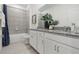 Well-lit bathroom featuring double sinks, modern fixtures, a shower-tub combination, and stylish decor at 1134 Clay Blvd, Tavares, FL 32778