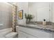 Well-lit bathroom featuring granite countertops, neutral tile, and modern fixtures at 1134 Clay Blvd, Tavares, FL 32778