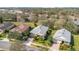 Aerial view of a well-maintained home with a gray roof and manicured landscaping in a suburban neighborhood at 117 Cupania Ct, Groveland, FL 34736