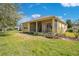 Expansive backyard featuring a covered patio area and lush green grass, ideal for outdoor activities at 117 Cupania Ct, Groveland, FL 34736