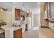 Well-lit kitchen features light wood flooring, stainless steel sink, and wood cabinets at 117 Cupania Ct, Groveland, FL 34736