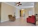 Bright living room showcasing modern flooring, a cozy recliner, and neutral paint colors at 117 Cupania Ct, Groveland, FL 34736