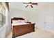 Inviting main bedroom with neutral walls, carpet, a ceiling fan, and natural light at 117 Cupania Ct, Groveland, FL 34736