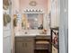 Pink bathroom featuring an expansive mirror with Hollywood lights, sink, and a powder chair at 11735 Whitewing Ct # 11735, Orlando, FL 32837