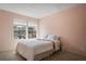 Bedroom with neutral walls, a queen-sized bed, and a pair of large windows at 11735 Whitewing Ct # 11735, Orlando, FL 32837