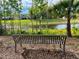 Scenic view of the lake from a bench with beautiful landscaping at 11735 Whitewing Ct # 11735, Orlando, FL 32837