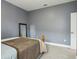 Simple bedroom featuring neutral gray wall paint with white trim and minimal decor at 1304 Sea Pines Way, Davenport, FL 33896