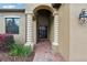 Inviting front entrance with decorative columns, brick pathway, and lush landscaping at 1304 Sea Pines Way, Davenport, FL 33896