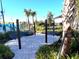 Hammock park features a sandy base, several hammocks, lush landscaping, and tropical palm trees at 1304 Sea Pines Way, Davenport, FL 33896