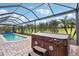 Enclosed pool area featuring a hot tub and clear blue swimming pool at 1304 Sea Pines Way, Davenport, FL 33896