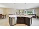 Kitchen island offers seating and stainless steel appliances at 1304 Sea Pines Way, Davenport, FL 33896