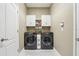 Well-equipped laundry room with modern washer and dryer units and storage at 1304 Sea Pines Way, Davenport, FL 33896