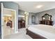 A luxurious bedroom with an elegant dresser and mirror, connected to other rooms at 1304 Sea Pines Way, Davenport, FL 33896