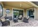 Relaxing covered patio area with comfortable wicker furniture and decorative outdoor accents at 1304 Sea Pines Way, Davenport, FL 33896