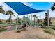 Community playground featuring a covered picnic area, slides, and a blue sunshade at 1304 Sea Pines Way, Davenport, FL 33896