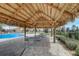 Inviting poolside cabana and patio area offering shaded seating and relaxation at 1304 Sea Pines Way, Davenport, FL 33896