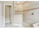 Bathroom with a shower stall featuring neutral tile, a decorative tile band, and glass partition at 1304 Sea Pines Way, Davenport, FL 33896