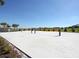 Outdoor volleyball court with bright blue sky and native trees at 1304 Sea Pines Way, Davenport, FL 33896