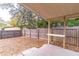 View of covered back porch and fenced backyard with mature trees at 134 E Plantation Blvd, Lake Mary, FL 32746