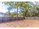 Wide backyard view showing mature trees, fenced perimeter, and lots of space at 134 E Plantation Blvd, Lake Mary, FL 32746