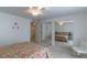 Bright bedroom with floral bedspread, mirrored closet, and a modern ceiling fan at 134 E Plantation Blvd, Lake Mary, FL 32746