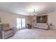 Bright living room featuring neutral colors, a decorative tapestry, chandelier and comfortable seating arrangement at 134 E Plantation Blvd, Lake Mary, FL 32746