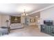 Cozy living room with chandelier, tapestry, and adjacent dining area with built-in cabinets and breakfast bar at 134 E Plantation Blvd, Lake Mary, FL 32746