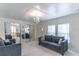 Comfortable living room featuring a plush sofa, mirrored closet doors and soft natural light at 134 E Plantation Blvd, Lake Mary, FL 32746