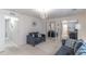 Stylish living room featuring a comfortable sofa, mirrored closet, and a chandelier at 134 E Plantation Blvd, Lake Mary, FL 32746