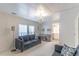 Cozy living room with a gray sofa, chandelier and view into bathroom at 134 E Plantation Blvd, Lake Mary, FL 32746