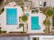 An aerial view of a community swimming pool features two pools, hot tub, lounge chairs and palm trees at 134 E Plantation Blvd, Lake Mary, FL 32746