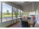 Relaxing screened-in porch with a wooden table and chairs overlooking the front yard at 134 E Plantation Blvd, Lake Mary, FL 32746