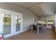 Enclosed porch with chairs and table, featuring access to the home's backyard area at 134 E Plantation Blvd, Lake Mary, FL 32746