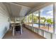 Covered screened-in porch with a table and chairs overlooking a well-maintained lawn at 134 E Plantation Blvd, Lake Mary, FL 32746