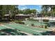 An overhead view shows multiple shuffleboard courts and clubhouse surrounded by mature trees and landscaping at 134 E Plantation Blvd, Lake Mary, FL 32746