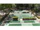 A high angle view shows multiple shuffleboard courts with manicured hedges and benches under a canopy of trees at 134 E Plantation Blvd, Lake Mary, FL 32746