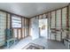 The unfinished room shows an open doorway to an enclosed outdoor space with a chair at 134 E Plantation Blvd, Lake Mary, FL 32746