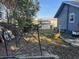 Backyard featuring a partial gazebo and a wheelbarrow adjacent to a light blue house at 1404 High St, Leesburg, FL 34748