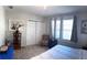 Bright bedroom featuring carpeted floors and natural light from three windows at 1404 High St, Leesburg, FL 34748