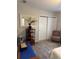 Bright bedroom featuring carpeted floors, a closet door, and neutral decor at 1404 High St, Leesburg, FL 34748