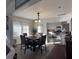 Elegant dining room with dark wood floors and plenty of natural light overlooking the kitchen at 1404 High St, Leesburg, FL 34748