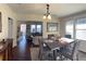 Elegant dining room with dark wood floors and plenty of natural light overlooking the living room at 1404 High St, Leesburg, FL 34748