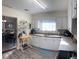 Bright kitchen featuring white cabinets, wood countertops, and modern gray flooring at 1404 High St, Leesburg, FL 34748