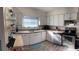 Well-lit kitchen featuring ample white cabinetry, stainless steel appliances, and modern flooring at 1404 High St, Leesburg, FL 34748