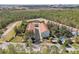 An aerial view showing the building and parking surrounded by lush green trees and vegetation at 14530 Damai Ln, Orlando, FL 32821